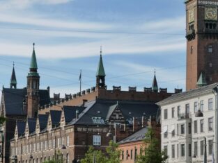 A scenic view of the historic City Hall building in Copenhagen, Denmark, showcasing its striking architectural details.