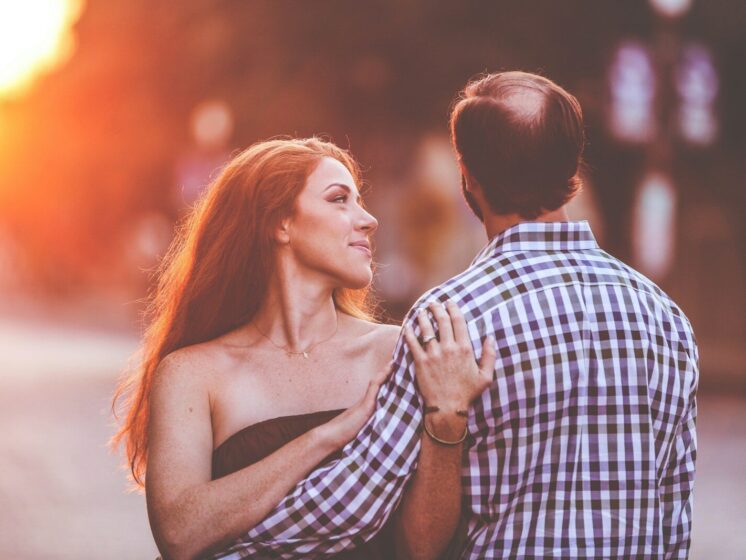 man and woman standing on road during daytime